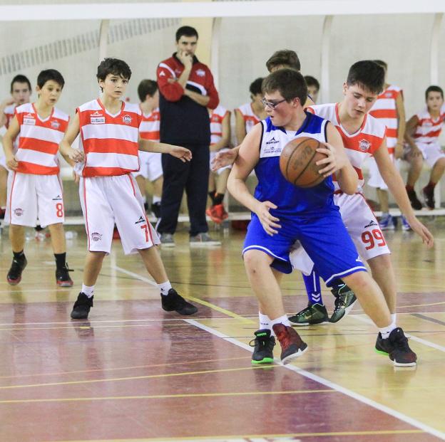 Un jugador, de espaldas al aro, trata de encontrar un hueco para avanzar. :: F.D./