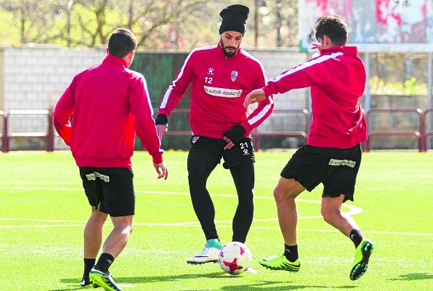 Salva Chamorro
juega el balón
ante la llegada de
Salvador y Santos.
:: fernando díaz/